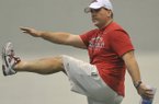 Arkansas assistant Charlie Partridge works with the Razorbacks during practice Saturday morning in Fayetteville.