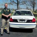 Zeb Rone, Tontitown police officer stands by his police car. Rone, and three other officers began pa...