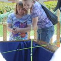Shelly Rogers, right, and daughter Kayla Rogers, 8, try their hand at fishing for trout at a fishing...