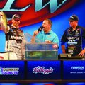Jason Christie, left, of Park Hill, Okla., holds up his fifth bass Sunday as he weighs in for the da...