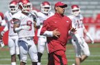Arkansas receivers coach Michael Smith works with his team during practice Saturday morning at Razorback Stadium in Fayetteville.
