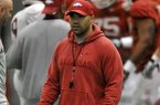 Arkansas Assistant Coach Joel Thomas works with the Razorbacks during practice on Saturday, March 30, 2013 in Fayetteville.