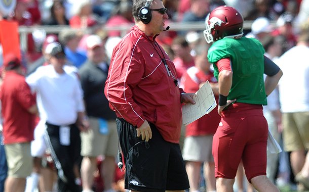 Arkansas coach Bret Bielema watches the Razorbacks warm up as they prepare for the start of Saturday's Red White Scrimmage at Razorback Stadium in Fayetteville.