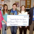 Walmart representatives Leslie McFarland (left) and Tim Surber (right) presented a $1,000 check to Decatur's band program for talent development on April 14. The community grant check was received by students Kathleen Lydon and Hailey Mead and Decatur band instructor Kristen Wages. Wages said the money would be used to purchase instruments for the Decatur band program, likely percussion instruments. 