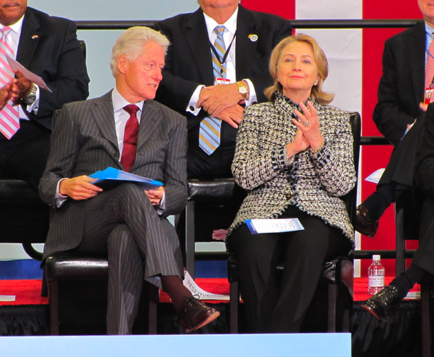 bill-and-hillary-clinton-sit-on-stage-during-a-dedication-ceremony-for-the-little-rock-airport-named-after-them