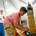Kristii Buttrey watches as her son, Deqlyn Buttrey, 10, sets up his research project Tuesday at Elmw...