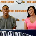 Deion Jones, left, Rogers Heritage senior, sits at a table with his mother, Leta Young, during a sig...