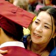 Gentry senior Randy Vang receives a hug from his mother, Mai Chor Xiong, during Gentry High School graduation ceremonies on Friday.
