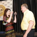 Miranda Tainter puts a medal on teacher David Chapman on Tuesday at Bentonville High School during A...