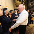 Jim Rollins, superintendent of Springdale Public Schools, center, speaks Saturday with graduating se...