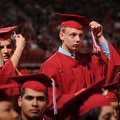 Savannah Breyfogle, left, and Austin Burkett move their tassels from right to left Saturday signifyi...