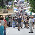 Visitors walk up Block Avenue during the Block Street Block Party. 