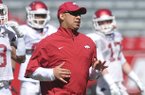 Arkansas Assistant/Wide Receivers Coach coach Michael Smith works with his team during practice Saturday morning at Razorback Stadium in Fayetteville.