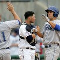 Kent Matthes of Tulsa is greeted by Kyle Parker following his fourth inning home run as Northwest Ar...