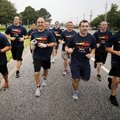 Rogers Police Department patrol officer Chad Pomielto runs with the Special Olympics Torch Monday mo...