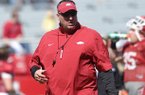 Arkansas coach Bret Bielema watches the Razorbacks warm up during practice April 6, 2013 at Razorback Stadium in Fayetteville.