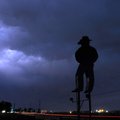Lightning streaks behind the clouds looking southeast Monday near Parson’s Stadium in Springdale. 