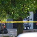 A member of the Bentonville Police Bomb Squad removes a gasoline can Wednesday from a room at a vaca...
