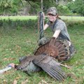 Elisa Daniel of Rogers shows an Osceola wild turkey she shot in Florida. The gobbler is one of four ...