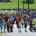 Students from John Tyson Elementary School walk Wednesday down Cambridge Street to Tyson Foods headq...