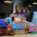 Hailey Porr, 7, labels a personal care packages “Kids Care Pac” on Wednesday at Victory Church in Sp...