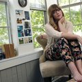 Keely Yount sits in her favorite place, the corner of her Rogers apartment that she uses as an alter...