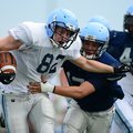 Zach Vaughn, left, Springdale Har-Ber tight end, is wrapped up by safety Katen Pullen after a first ...