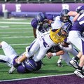 Fayetteville’s Terrell Tyson, center, reaches to score a touchdown as he is hit at the goal line dur...