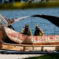 Northeast Benton County firefighters survey the damage Friday to a barge following explosions near t...