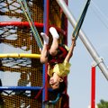 Daniel Martinez, 7, of Pea Ridge flips Friday on the bungee jump amusement ride at the Rogers Activi...
