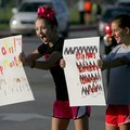 Olivia Lisle, left, and Caroline Rhodes, both Hellstern Middle School seventh-graders, promote donat...