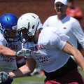 Josiah Wymer, right, Springdale tight end, moves to avoid a blocker as he participates in drills whi...