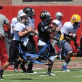 Campers participate in drills Monday during football camp at the University of Arkansas. 