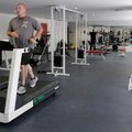 Eric Evans, a Springdale police patrolman, runs on the treadmill at the end of his workout Tuesday a...