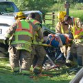 Springdale emergency responders work Tuesday on removing one of the occupants of a Toyota Corolla in...