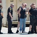 Springdale police officers take Noah Dillaplane into custody Tuesday in the parking lot in front of ...