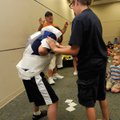Magician Marty Boone watches Matthew Furnish, left, get turned into a mummy with tissue paper by Hav...