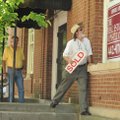 Mark Risk, right, real estate agent, works Wednesday with new building owner Jim Huson, left, to put...