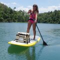 Debbi Neece enjoys a warm afternoon on June 7 at Beaver Lake on her stand-up paddle board. Paddle bo...