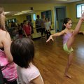 Taylor Rogers, left, instructor, watches Reigan Lutz do kick exercises Thursday during dance camp at...