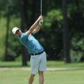 Icem Brewer of Fayetteville watches his approach shot sail to the No. 1 green Friday during the 75th...