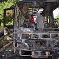 Pakistani volunteers collect body parts of victims of a bomb blast from the wreckage of a bus in Que...