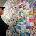 Wayne Anderson of Columbia, Mo., looks over the “Wal-Art” mural Thursday off the square in Bentonvil...