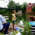 Mia Dence, 7, of Bentonville fishes with her grandparents, Ken (left) and Vicki Mitchell, both of Gr...