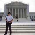 A police officer keeps watch outside the Supreme Court in Washington, Monday, June 17, 2013. With a ...