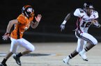 STAFF PHOTO SAMANTHA BAKER -- Pine Bluff Dollarway High School's Joshua Liddell, 12, outruns Dallas Kerley, 34, of Gravette High School Friday, Nov. 25, 2011, at Lion Stadium in Gravette.
