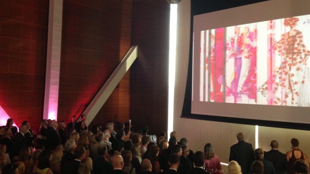 patrons-at-the-clinton-presidential-center-great-hall-watched-a-video-from-oscar-de-la-renta-american-icon-during-the-dedication-of-exhibit-featuring-dresses-from-the-famous-fashion-designer-on-monday-night