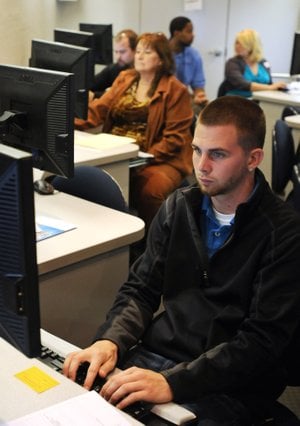 Dustin Breedlove, from Rogers, fills out an application for employment ...