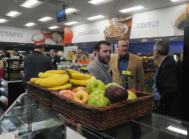 
                      Photo by Flip Putthoff<br />
                      Customers browse the offerings Tuesday at Wal-Mart’s newly opened convenience store in Rogers.
