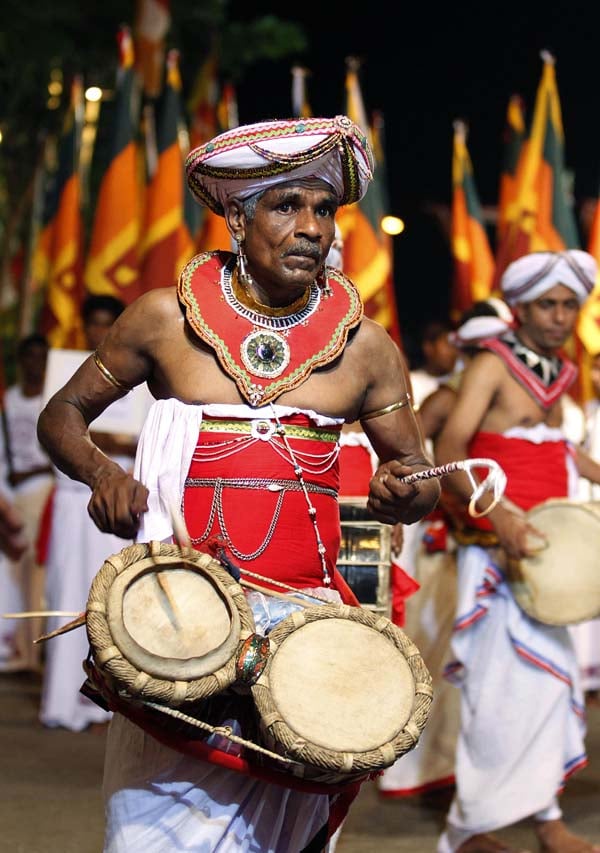 A traditional Sri Lankan dancer performs during an annual Buddhist ...